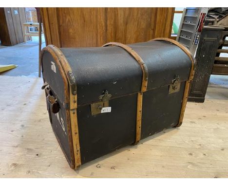 An early 20thc travelling trunk, dome topped with bent metal bound with brass bumpers, interior with single shelf, measures 5