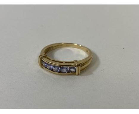 A 9ct gold ring with five amethyst stones size R weighs 2.76 grammes