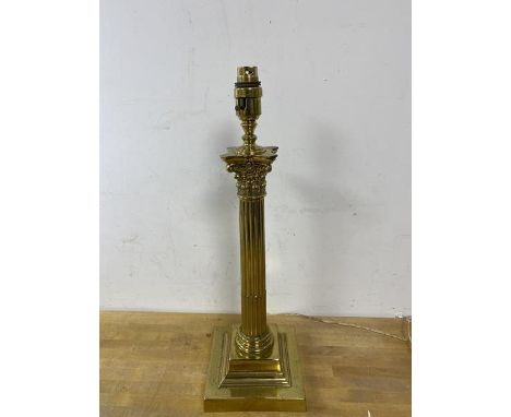 A corinthian column table lamp with brass finish measures 47cm high