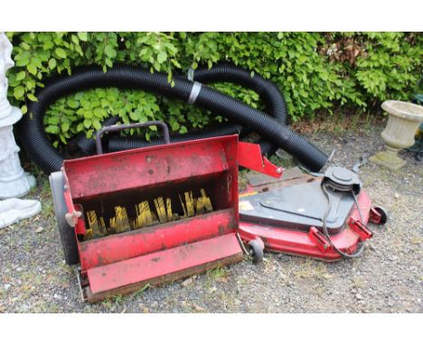 A cutting deck and sweeper and a piece of pipe