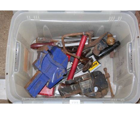 A box of various tools to include two bench vices