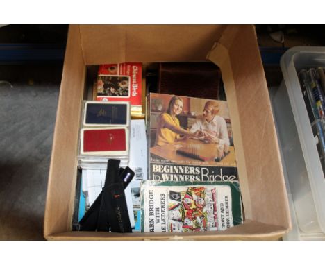 A box of playing cards and bridge related items
