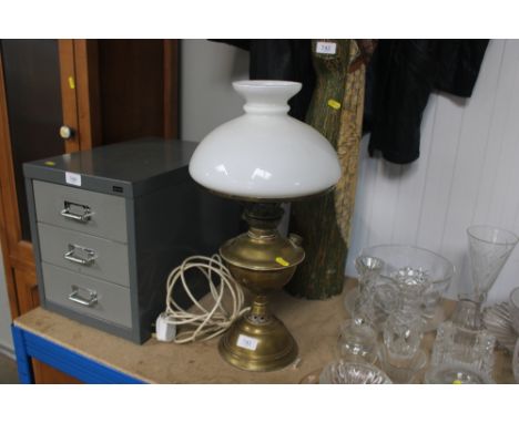 A brass oil lamp and shade converted to electricity