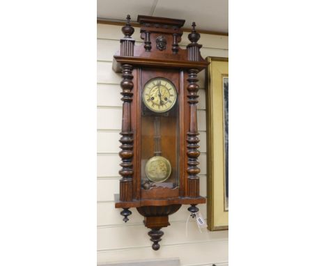 A 19th century German architectural beech and walnut wall clock,100 cms high,