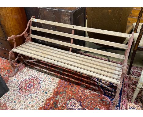 A Coalbrookdale style cast iron garden bench with dog's head and serpent terminals, length 158cm