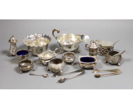 A small collection of mixed silver to include cased cutlery, a ladle, sauceboats, condiments, etc.