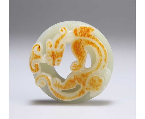 A CHINESE CARVED JADE DISC with a feline-like creature. 5.3cm diameterIn good condition.