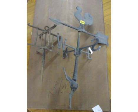 A reproduction cast metal weather vane, together with a garden implement