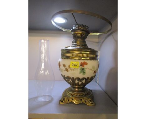 A late 19th century brass oil lamp having a cream glass reservoir, 21 1/4 h