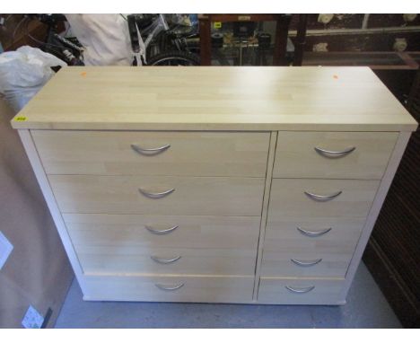 A modern light wood chest of five long and five short drawers, 33 h x 42 w