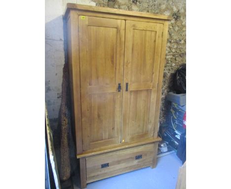 A modern light oak wardrobe having twin doors and a single drawer below, 76 h x 43w