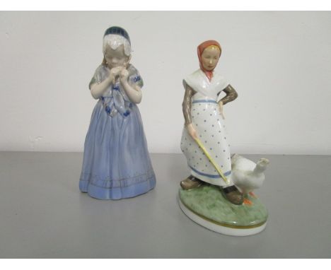 A Royal Copenhagen porcelain figurine, signed to the base Lotte Beuter, of a young girl playing with her hair and a Royal Cop