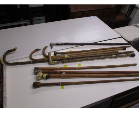 A collection of walking sticks and canes to include one with a white metal top, probably Burmese and a Japanese stick (10)