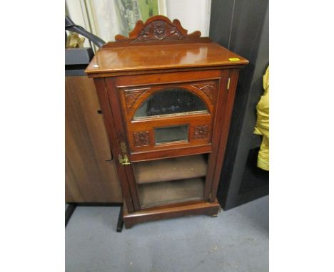 A Victorian mahogany music cabinet with an extended carved back and mirrored door, above open shelves on bracket feet, 37 x 2