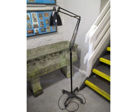 A black, four wheeled adjustable Anglepoise lamp by Herbert Terry