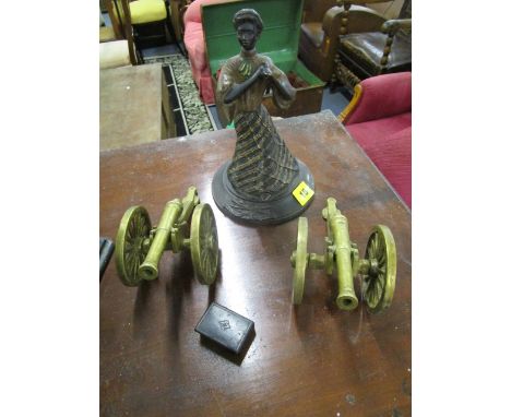 An early 20th century brass figurine of a lady, a 19th century papier-mâché snuff box and two brass cannons