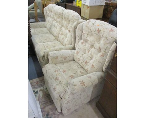 A modern floral upholstered, two seater sofa and matching armchair