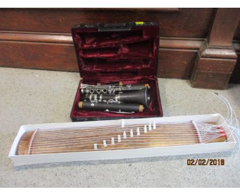 A cased clarinet and a modern Japanese wooden instrument