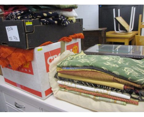 A quantity of full length coloured voile curtains, together with a quantity of fabric samples and off cuts suitable for uphol