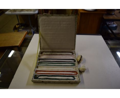 A box of hard stone necklaces; a shell and white metal mounted snuff box; and a small shell purse  