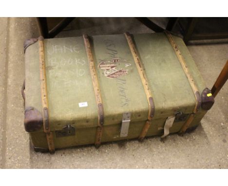 A canvas and wooden bound travelling trunk 