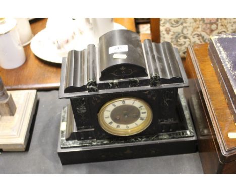A late Victorian black slate two hole mantel clock 