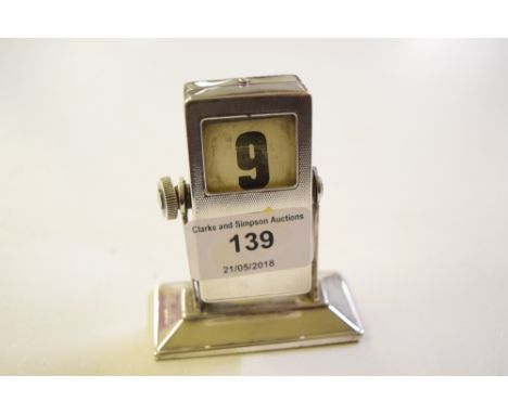 A silver cased desk calendar with engine turned decoration