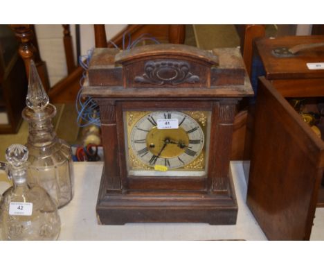 An early 20th Century oak two hole mantel clock