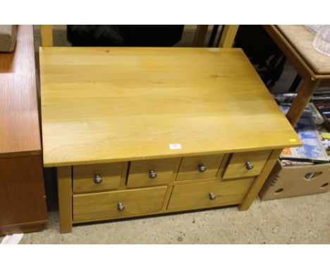 A light oak multi drawer coffee table with lift-up top 