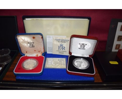 A Silver Jubilee stamp in Sterling silver; together with a Silver Jubilee crown with case and certificate; and a 40th Anniver