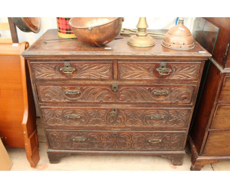 A GEORGE III AND LATER OAK CHEST of two short and three graduated long drawers with later carved decoration, bracket feet 108