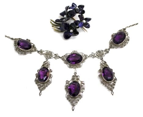 A PASTE AMETHYST TYPE STONE WHITE METAL NECKLACE with scroll decoration around the oval stones, together with an enamel decor