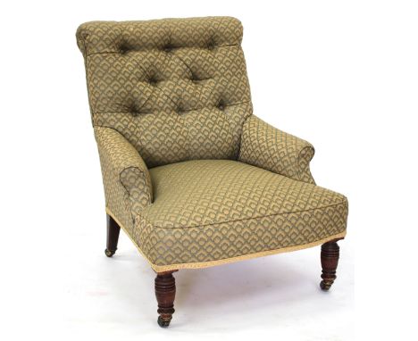 AN OLD BUTTON UPHOLSTERED ARMCHAIR with ring turned tapering front legs terminating in ceramic castors 70cm wide 