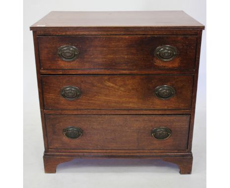 AN ANTIQUE MAHOGANY CHEST of three long drawers with oval handles and standing on bracket feet 79.5cm wide x 81cm high 