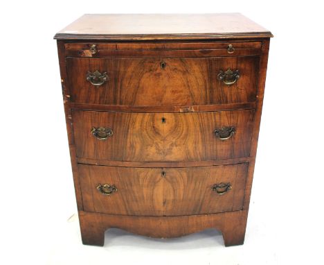 A SMALL GEORGIAN STYLE MAHOGANY BOW FRONTED CHEST with cross banded top and brushing slide over three drawers, all on bracket