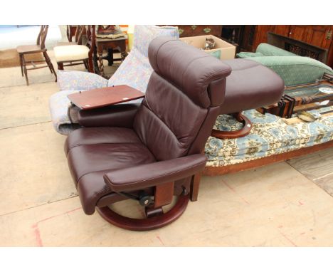 A BROWN LEATHER UPHOLSTERED "STRESSLESS" RECLINING ARMCHAIR together with a matching stool, the chair approximately 84cm wide
