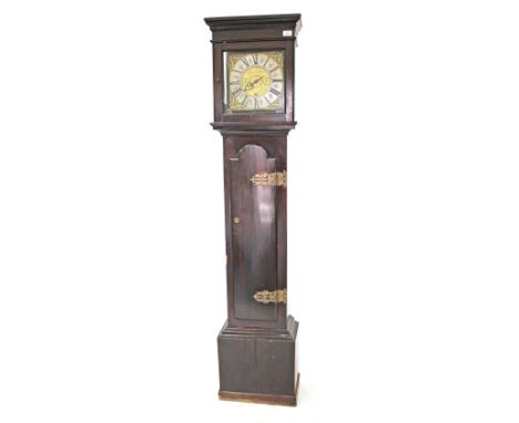 AN ANTIQUE 30-HOUR LONG CASE CLOCK, with dark stained wooden case, the trunk door with strapwork hinges, the brass squared di