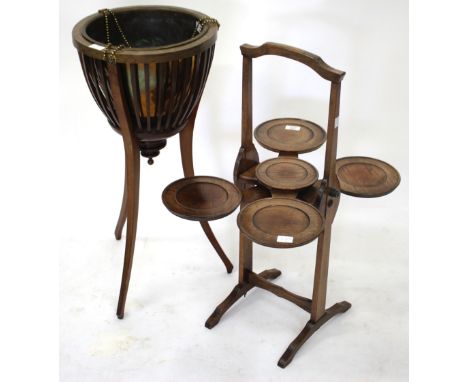 AN EDWARDIAN MAHOGANY JARDINIERE with circular top, spun brass liner, lion mask decoration with beard swags and on a  tripod 