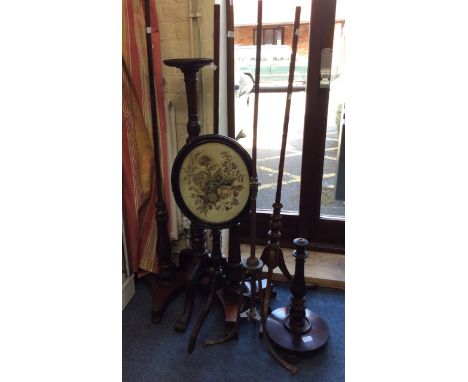 A VICTORIAN BRASS POLE SCREEN STAND with tripod base together with a group of five various pole screen bases and a torchiere 