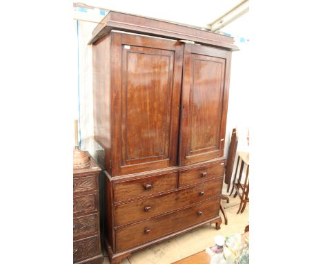 A VICTORIAN MAHOGANY LINEN PRESS with two panelled doors, slides, two short drawers, two long drawers and ogee bracket feet 1