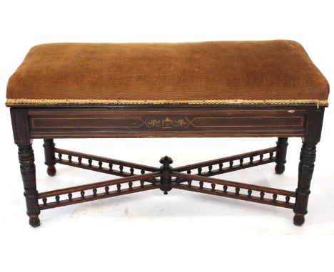 AN OLD MAHOGANY OVERSTUFFED UPHOLSTERED BOX SEAT PIANO STOOL with decorative inlay and turned legs united by a galleried X st