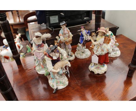 A PAIR OF SITZENDORF PORCELAIN FIGURES of bird sellers 23cm high together with a pair of Sitzendorf figures of a shepherd and