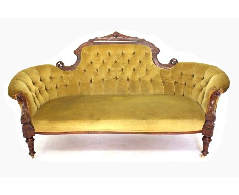 A VICTORIAN MAHOGANY FRAMED BUTTON UPHOLSTERED SETTEE with scrolling arms, turned front legs and brass casters, 180cm wide