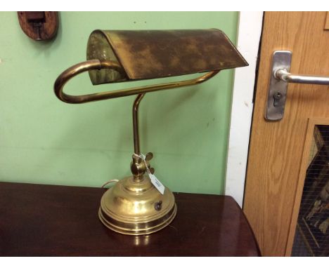 A BRASS DESK LAMP with circular base 39cm high 
