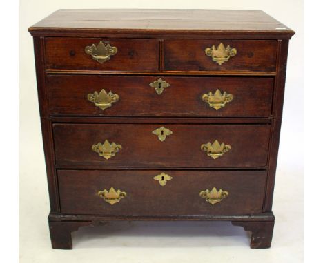 A GEORGE III OAK CHEST of two short and three long drawers standing on bracket feet with brass handles 94cm wide x 93.5cm hig
