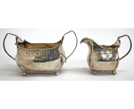 A GEORGE III IRISH SILVER SUGAR BASIN with engraved band of stylised flower decoration, looping handles and standing on ball 