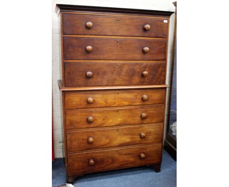 A MAHOGANY CHEST ON CHEST with three long drawers above four further drawers all with turned knob handles and all on bracket 