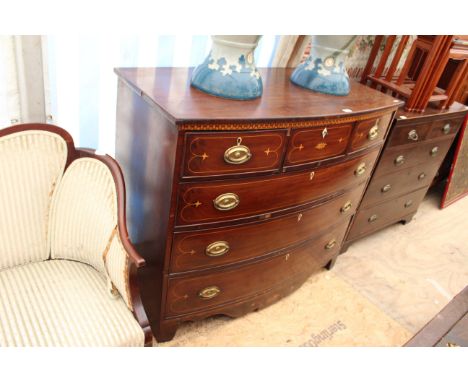 A 19TH CENTURY MAHOGANY BOW FRONTED CHEST of three short and three long drawers having satinwood inlaid decoration and brass 