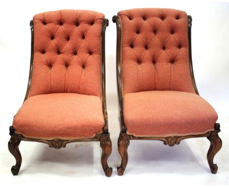 TWO SIMILAR VICTORIAN ROSEWOOD BUTTON UPHOLSTERED SIDE CHAIRS with acanthus leaf scroll carved frames and cabriole front legs