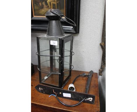 AN OLD IRON FOUR GLASS HANGING LANTERN 42cm high together with a suspension bracket 